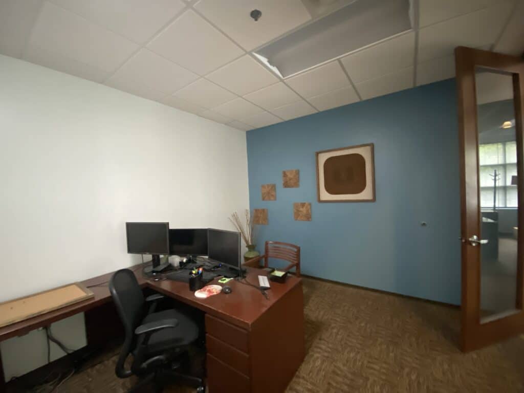 Corner office with teal accent walls and commercial carpet - Kemco tenant improvement Dunwoody GA