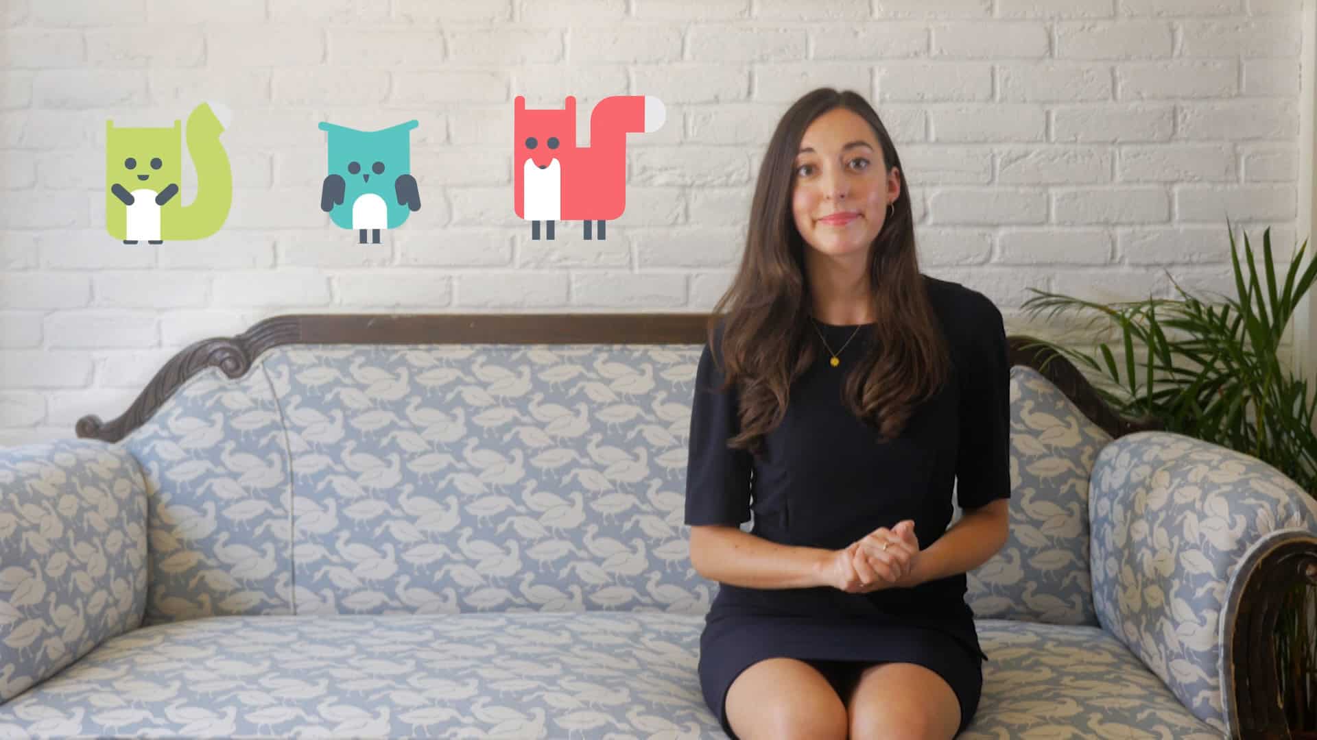 Person in yellow puffer jacket adjusting small sunglasses while standing outdoors against red-trimmed windows with graffiti in sunlight.