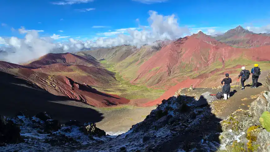 Group of trekkers exploring colorful mountain landscape in Cusco, Peru.