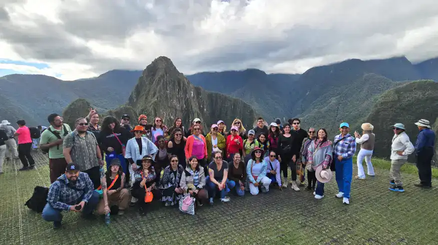 Tourists at Machu Picchu with stunning mountain views in Cusco, Peru.