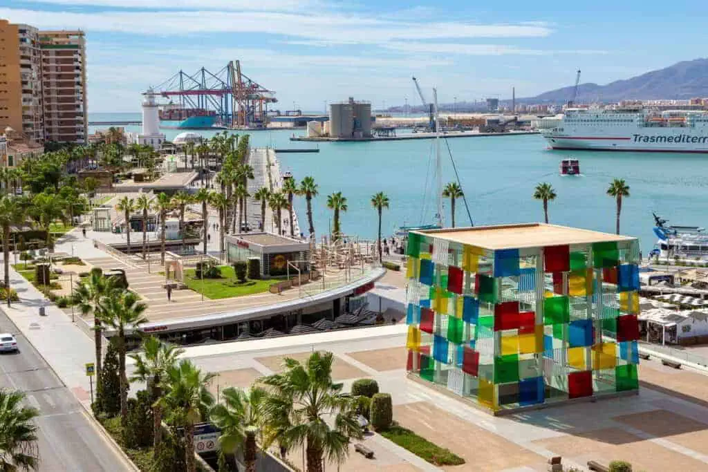 Restaurantes con terrazas frente al mar en Muelle Uno, Málaga, bajo un cielo azul.