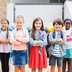 Classroom children standing outdoors at Mangorei School in New Zealand, smiling, diverse group, happy students, school community.