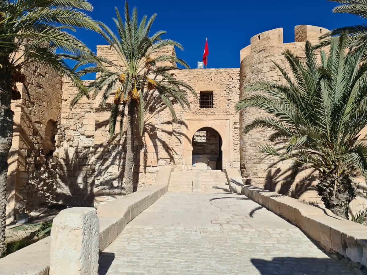 Historic Borj El K'bir fortress surrounded by palm trees in Houmt Souk, Djerba Island—one of the top historical places to visit in Tunisia.