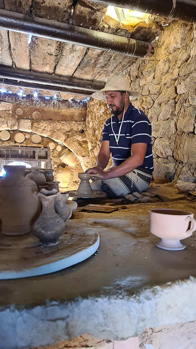 Tunisian artisan shaping clay at a traditional pottery studio in Guellala, Djerba – one of the best cultural places to visit in Tunisia to experience local Berber crafts.
