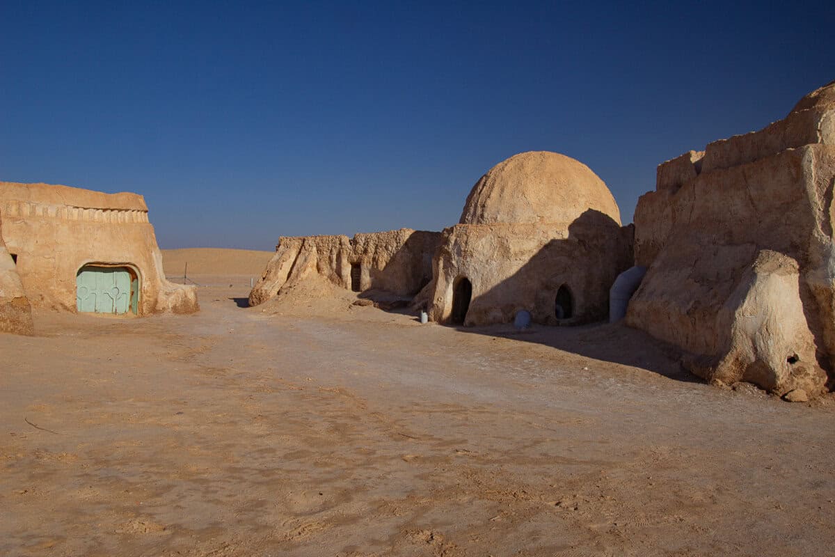 Desert landscape and round adobe structures of the Mos Espa film set in Tunisia, a must-visit for anyone interested in pop culture and filming locations in North Africa.