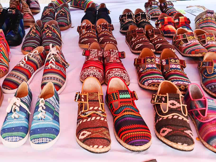 A colorful display of traditional alpargatas, lightweight canvas shoes with vibrant patterns, available at an artisan market in Argentina. A perfect souvenir for style and comfort, reflecting Argentine culture.