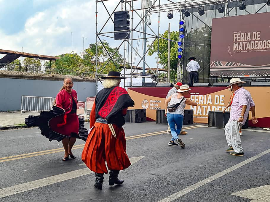 Folk dancers performing traditional Argentine dances at Feria de Mataderos in Buenos Aires. A vibrant cultural hub and the perfect place to shop for authentic Argentinean souvenirs and unique Argentina gifts.
