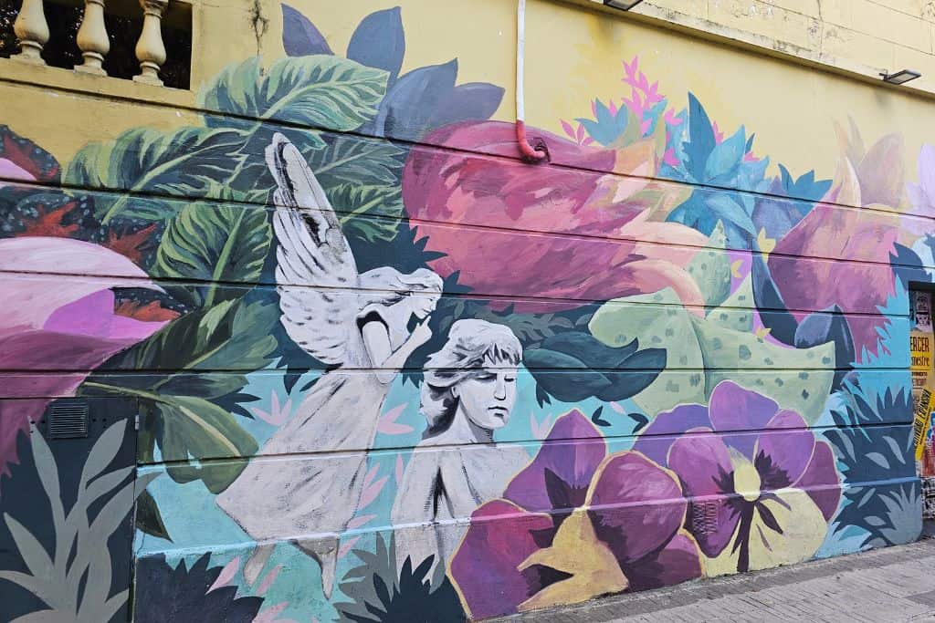 A mural of an angel and flowers. Palermo Soho in Buenos Aires is known for its murals and visiting it is one of the best things to do in Buenos Aires for street-art lovers.