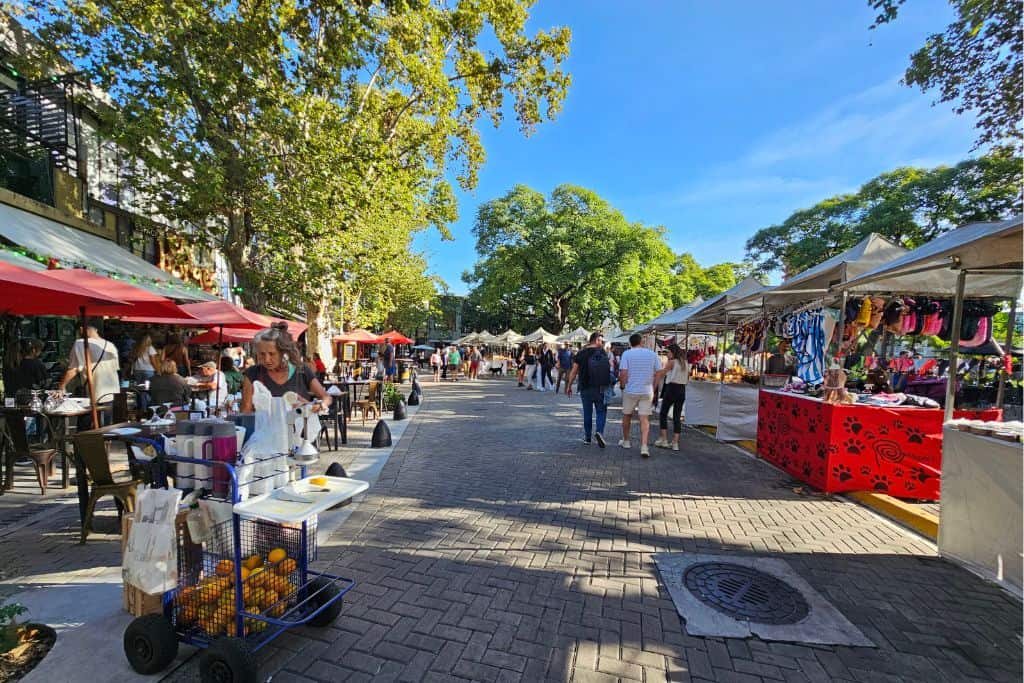 Street market at Plaza Serrano in Palermo Soho Buenos Aires. Visiting the vibrant street markets is one of the nest things to do in Buenos Aires.