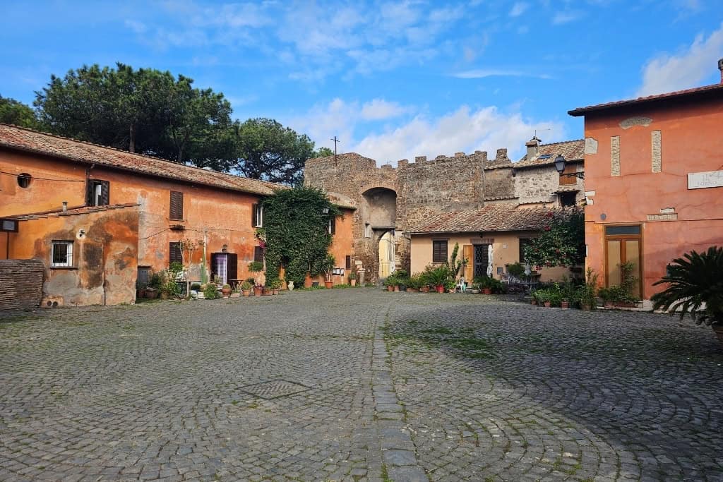 Cobblestone square in Ostia Antica village, a charming stop while visiting Ostia Antica.