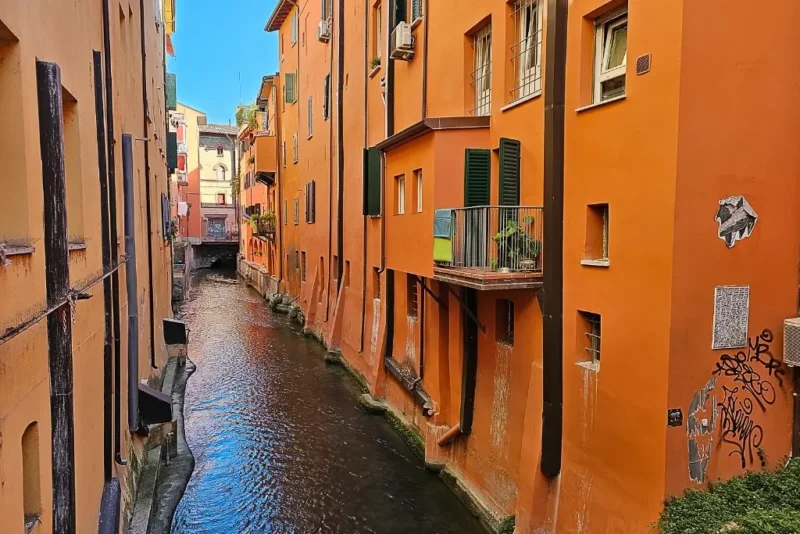 Narrow canal flanked by terracotta-colored buildings in Bologna’s historic center, often called “La Piccola Venezia” or Little Venice—a hidden gem for urban and canal photography in Bologna.