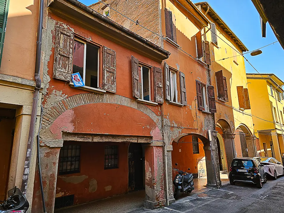 Rustic facades and archways along a quiet residential street in Bologna’s historic center—perfect for capturing authentic, everyday moments of local life.