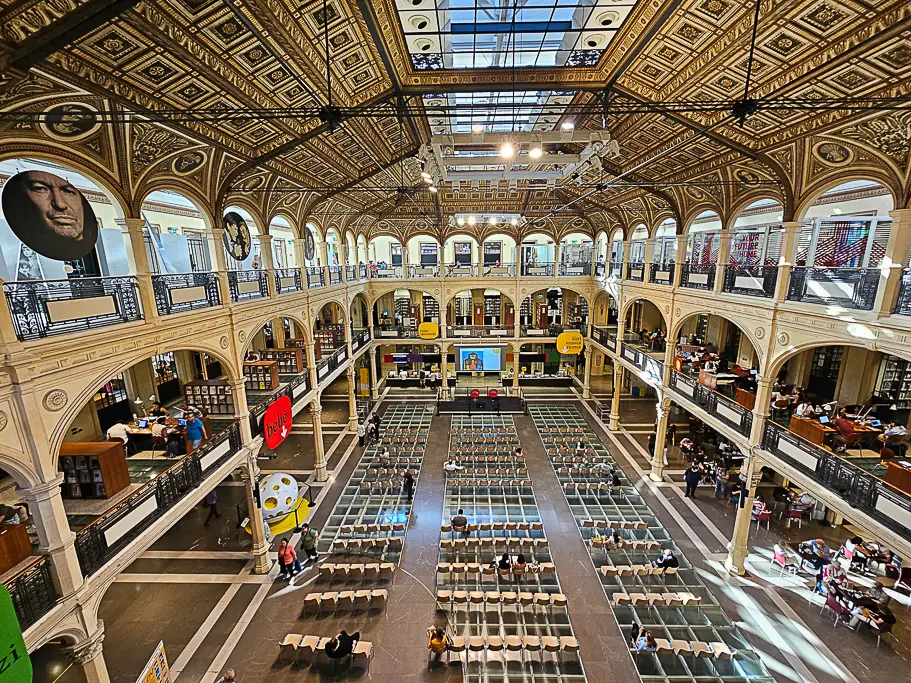 Grand interior of Bologna’s Sala Borsa Library with its glass floor, neoclassical arches, and reading areas—a top cultural and architectural photo spot near Piazza Maggiore.