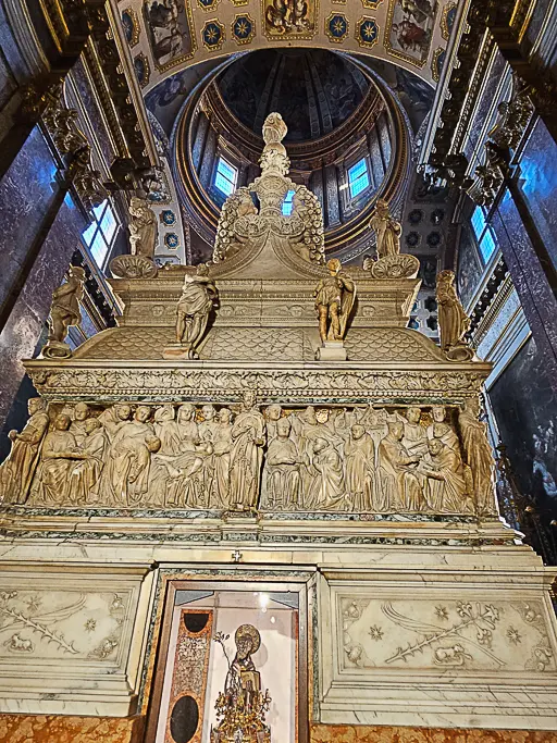 Detailed marble reliefs on the rear side of the Arca di San Domenico in Bologna, showcasing fine Renaissance sculpture inside the Basilica of San Domenico—a must-see sacred art masterpiece.