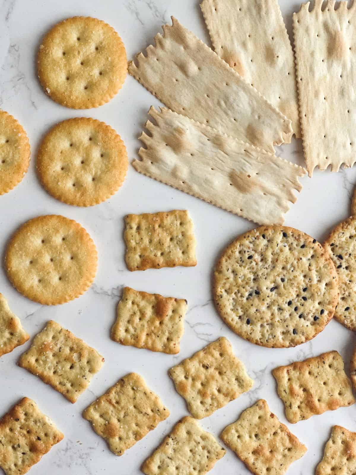 An assortment of crackers on a marble counter top.