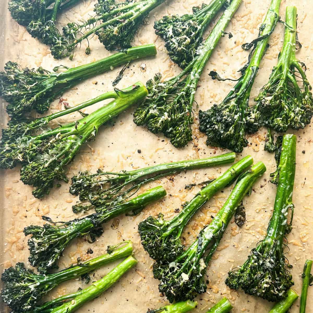 Charred broccolini on parchment paper.