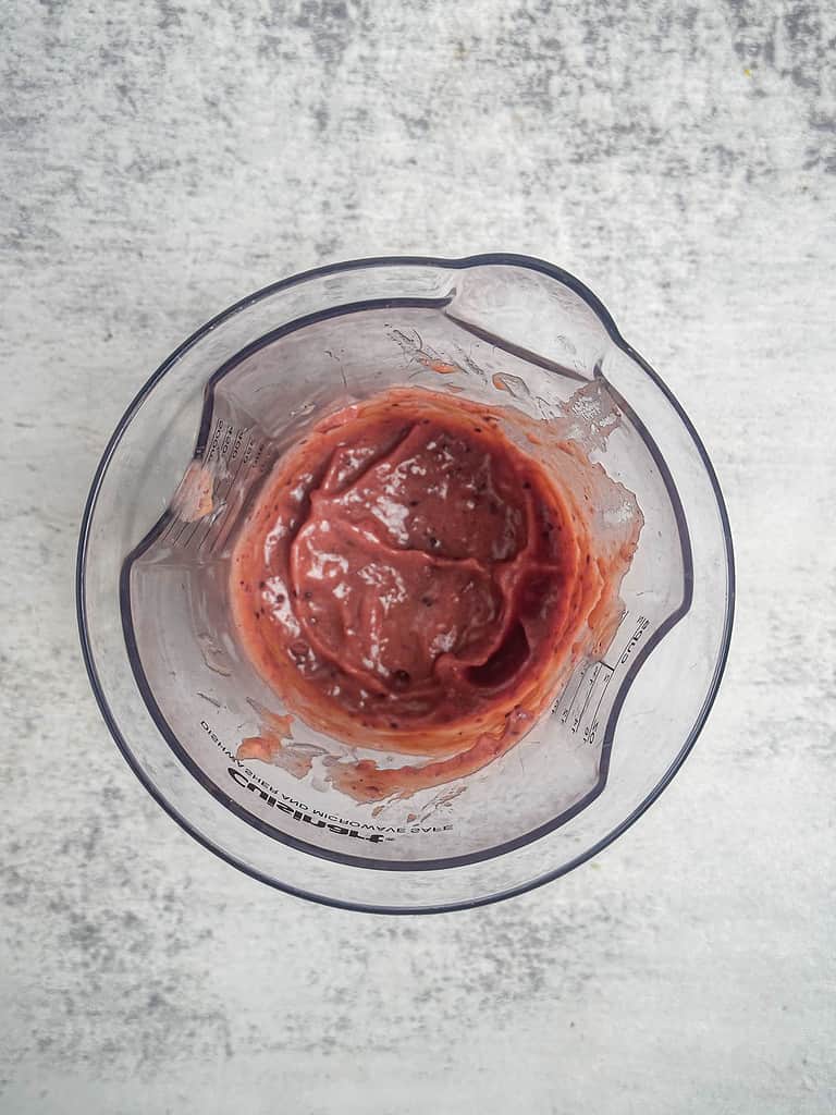 Cranberry honey mustard sauce in a immersion mixer cup.