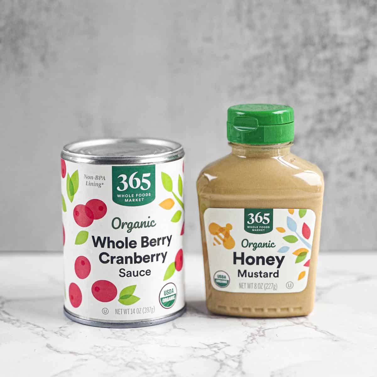 A can of whole berry cranberry sauce and a squeeze bottle of honey mustard.