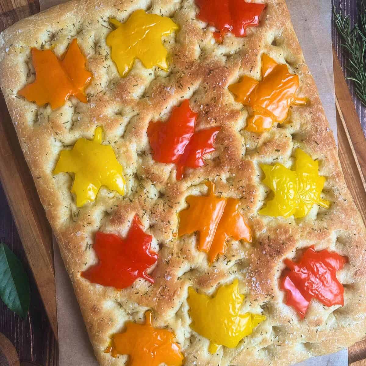 Focaccia bread with maple leaf shaped bell peppers on top