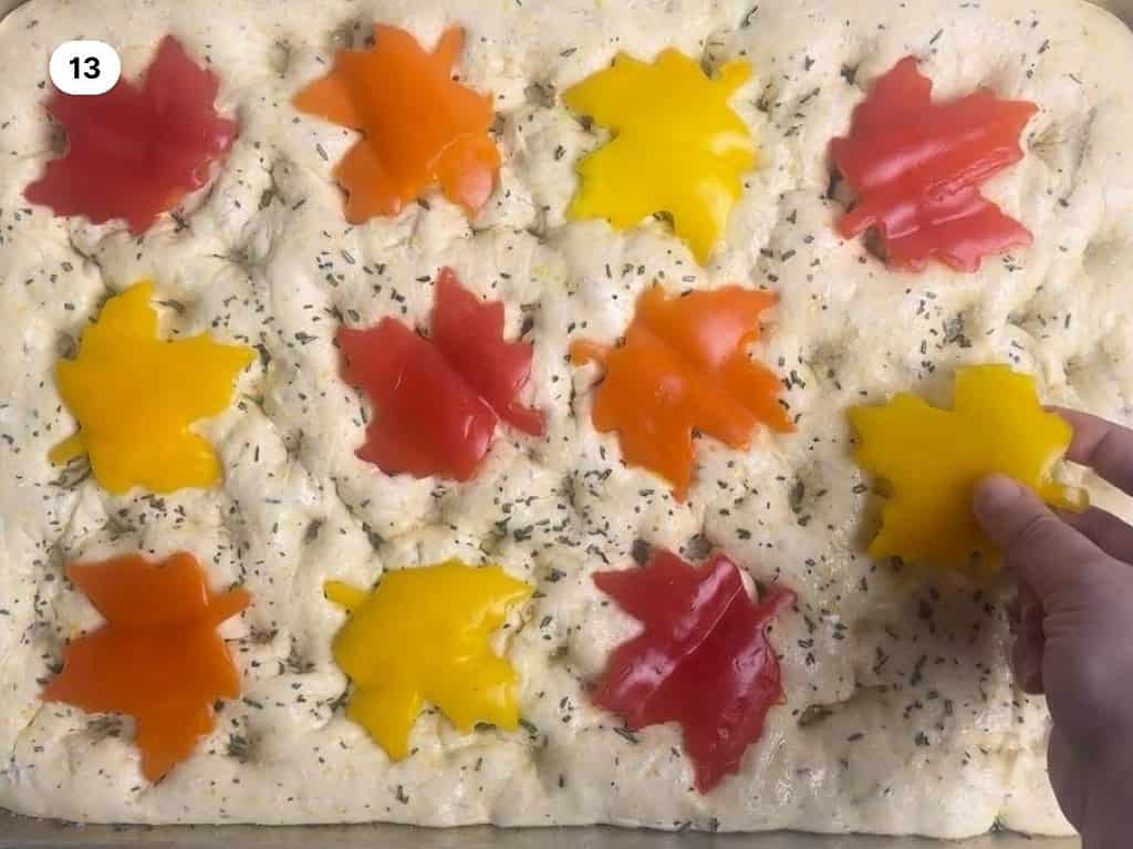 Fall focaccia bread recipe process shot thirteen, adding the maple leaves.