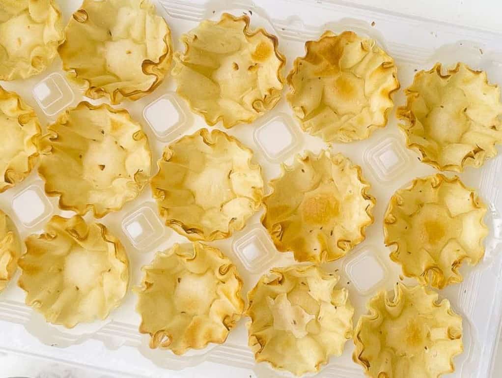 A tray of prepared phyllo cups without any filling.
