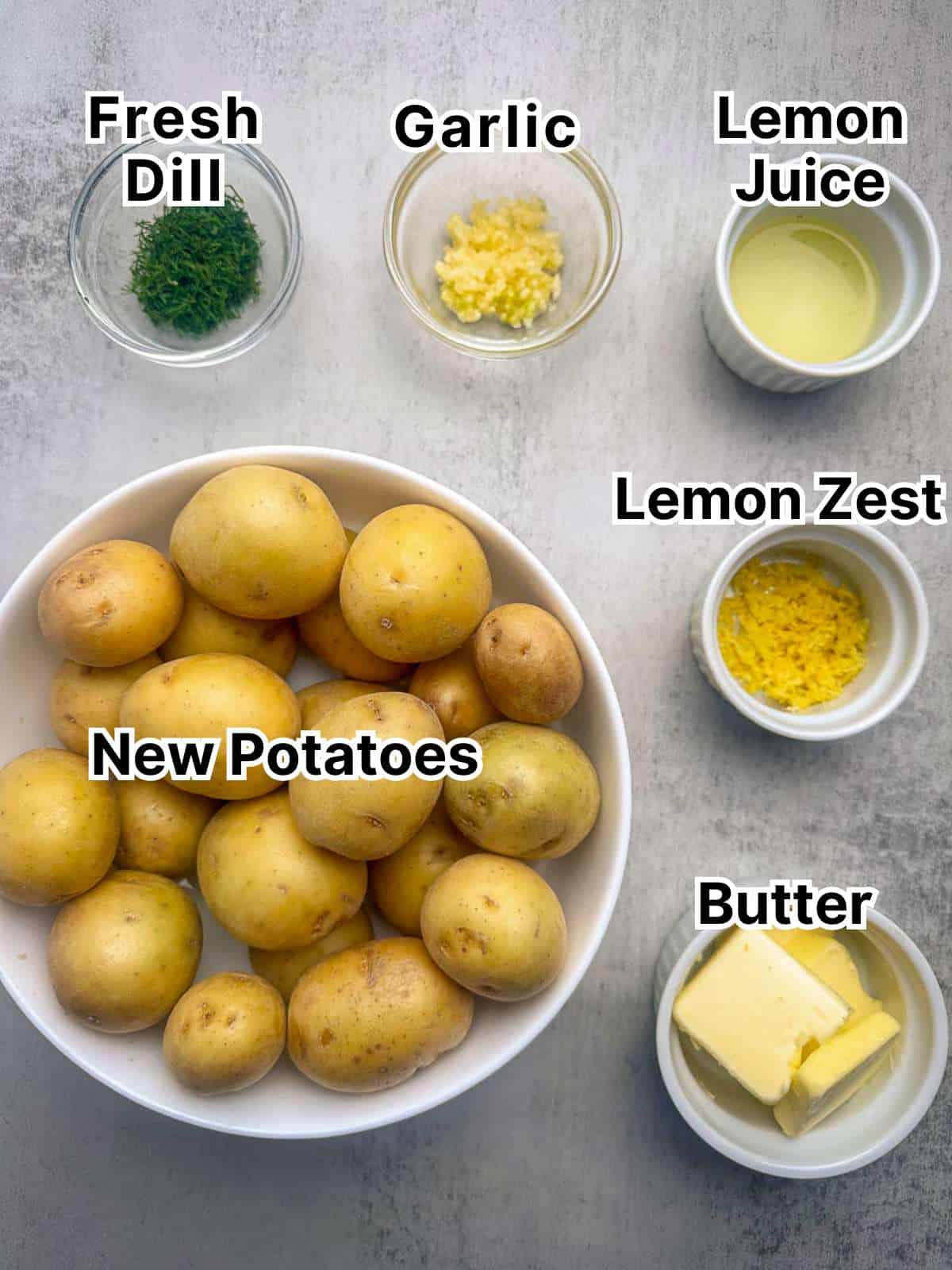 New potatoes, butter, lemon zest, lemon juice, garlic, and dill in small bowls.
