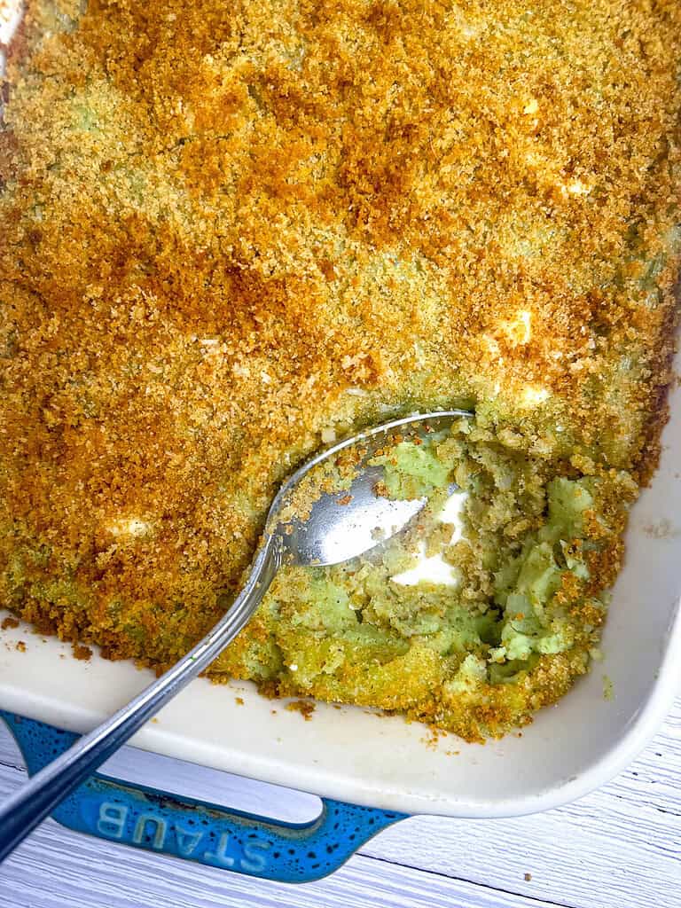 Pesto mashed potatoes in a baking dish, au gratin-style with breadcrumb topping.