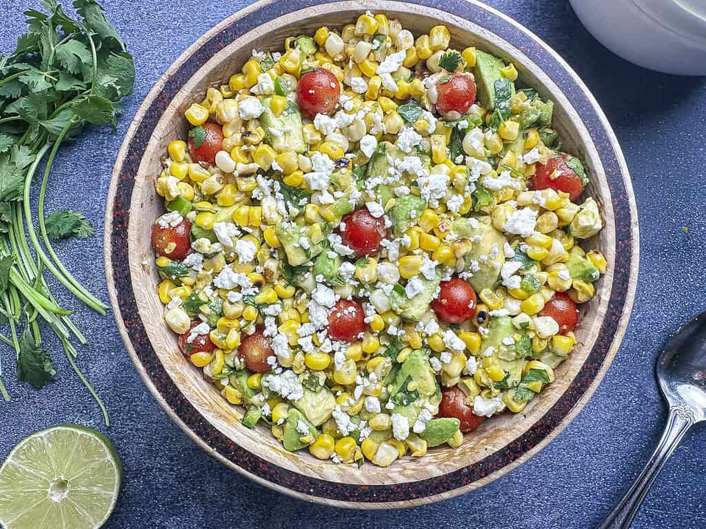 Charred corn salad with lime and cilantro on the side.