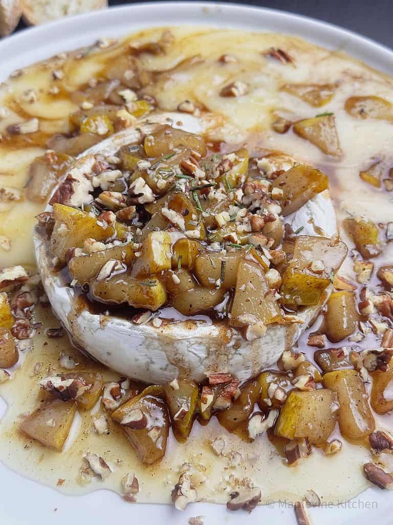 Baked brie with pears, pecans, and honey.