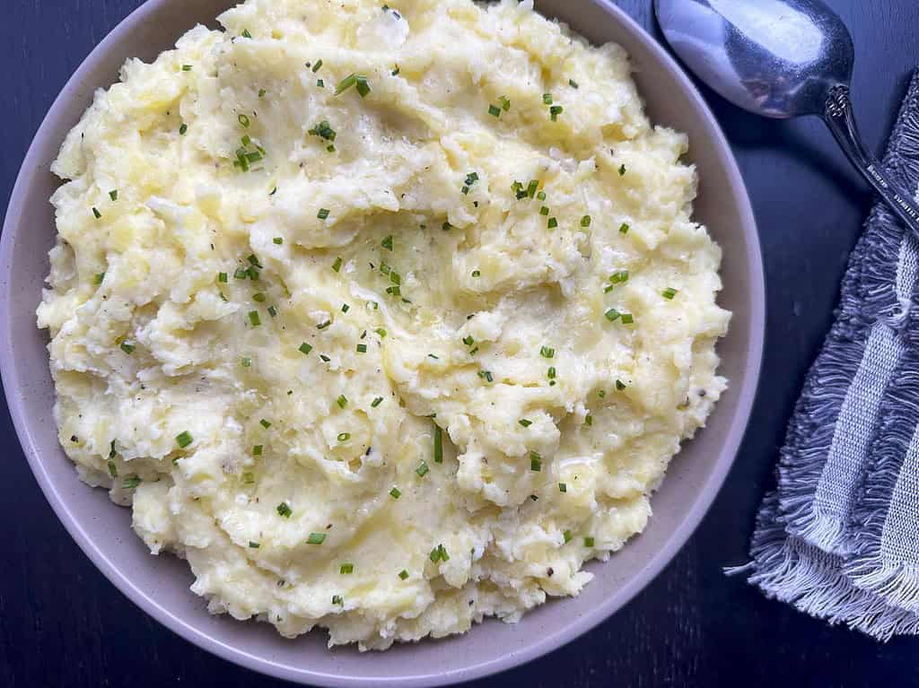 Mashed potatoes with truffle oil in a bowl.