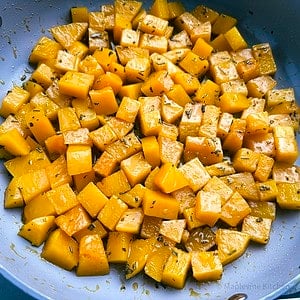 Glazed butternut squash in a skillet.