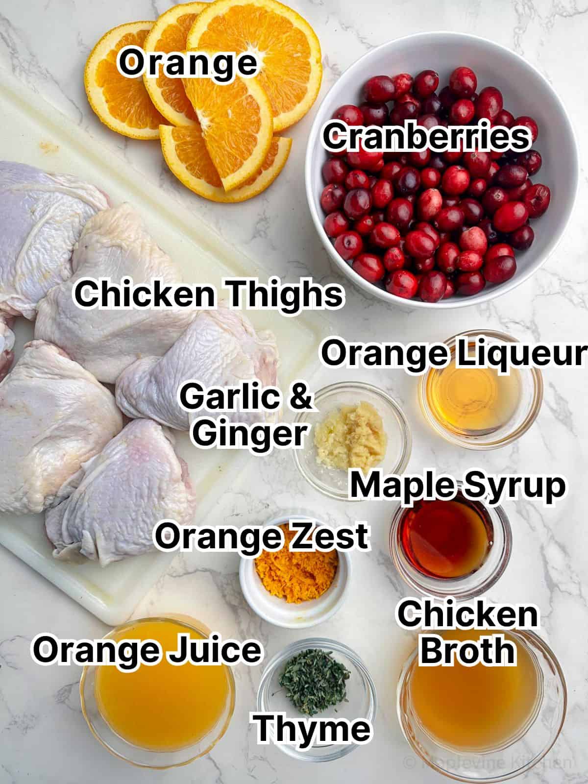 Holiday chicken recipe ingredients in small dishes on a marble counter top.