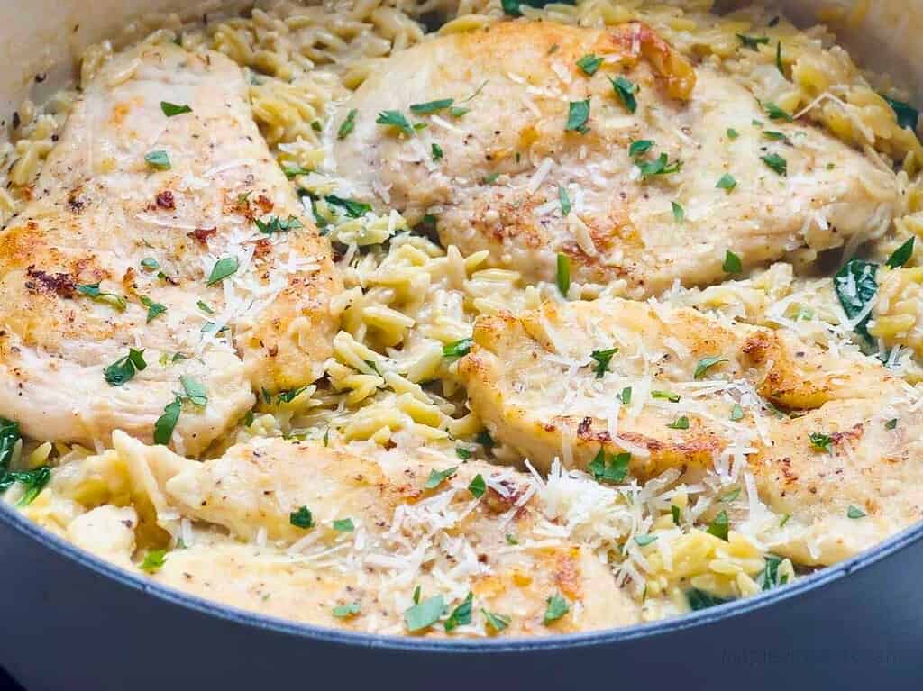 Lemon chicken orzo pasta in a Dutch oven.