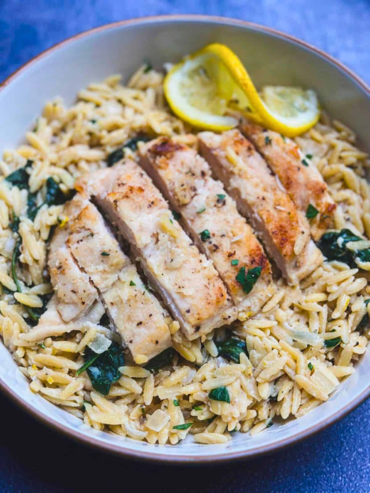 Creamy lemon chicken orzo pasta in a shallow bowl.