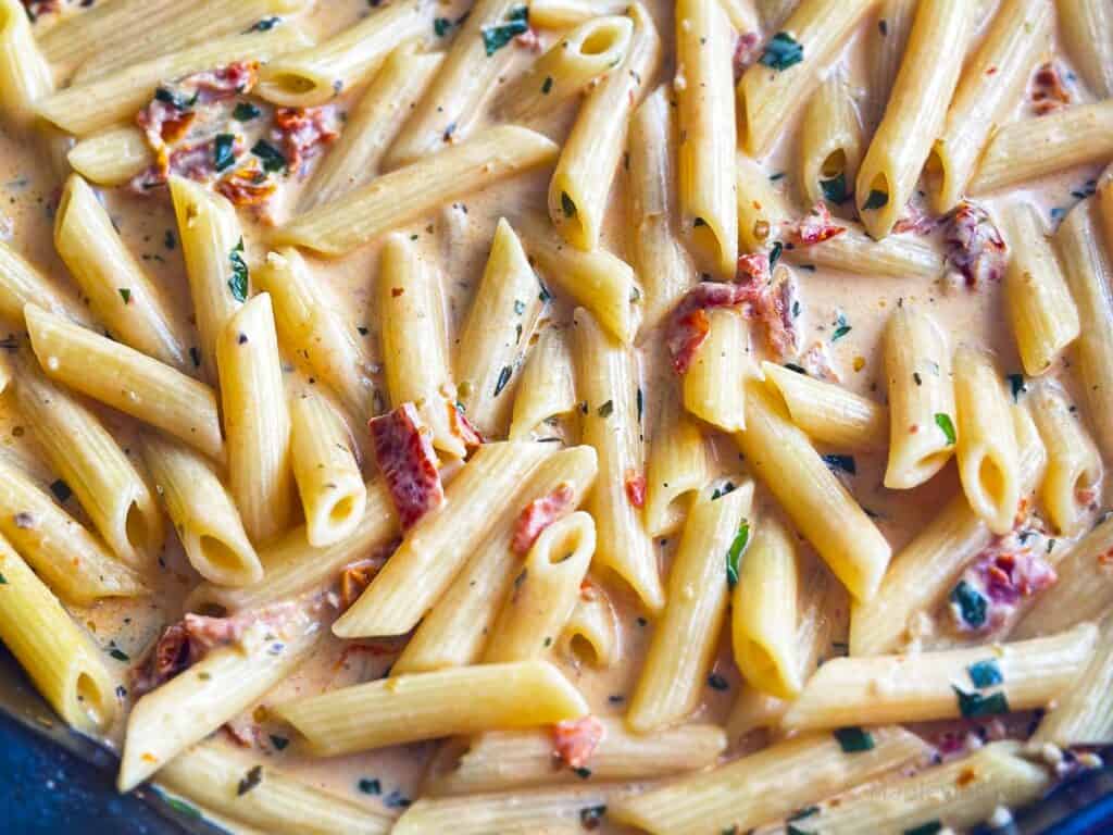 Penne in a creamy sauce with sun-dried tomatoes and basil.
