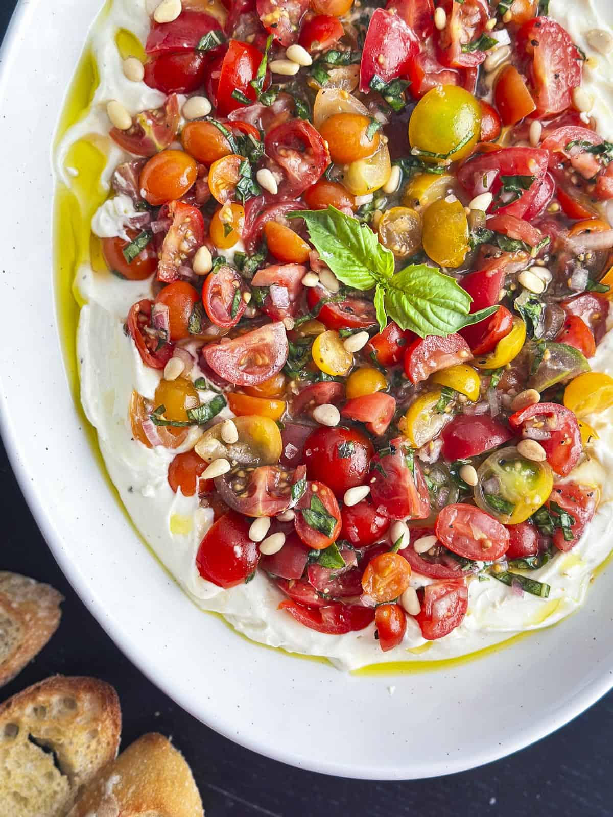 Whipped feta dip topped with tomato bruschetta.