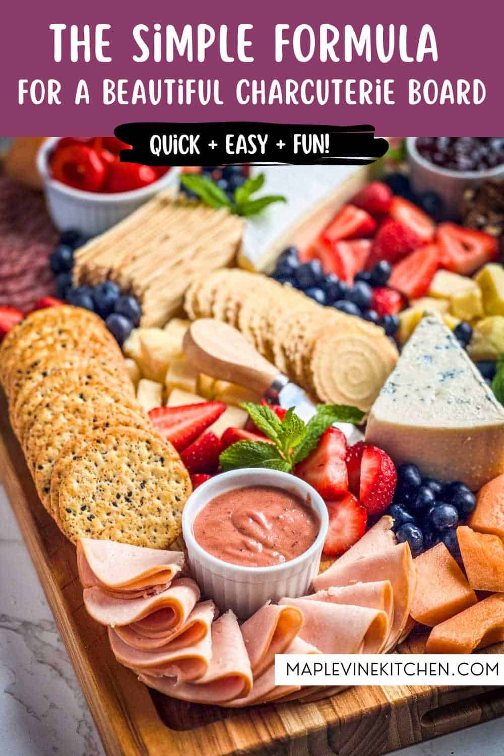 Colorful charcuterie board with cheese, fruits, and crackers for entertaining.