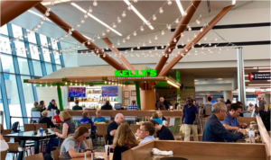 Kelly's restaurant at an airport with many customers and a modern interior.