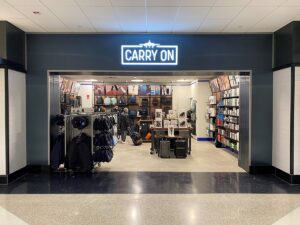 Carry On store entrance with clothing and accessories display inside.