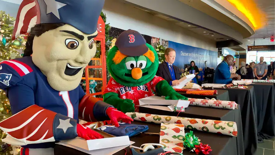 Mascots and wrapped gifts at a festive event in a shopping mall.
