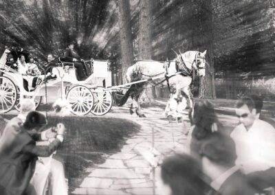 A black and white photo of a horse drawn carriage.