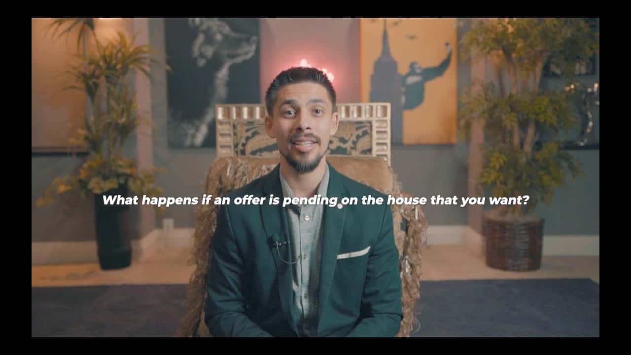 Elegant man in a suit explaining real estate offers in a stylish Edmonton home interior.