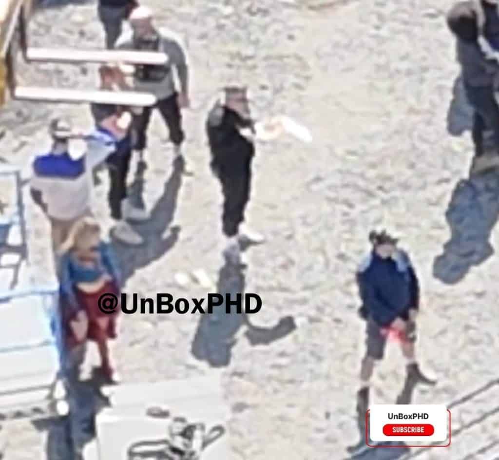 Alcock is seen wearing the Supergirl suit with the iconic 'S' logo clearly visible.