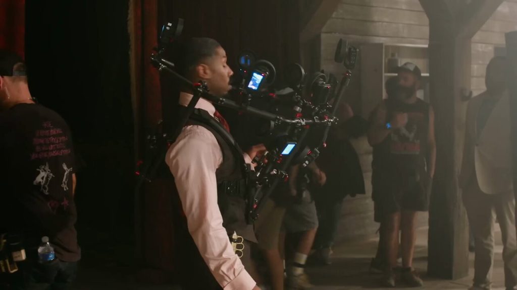 Warner Bros. Pictures reveals how twin scenes in Sinners were filmed using the innovative Halo Rig—featuring 10–12 cameras to capture Michael B. Jordan’s face and map it onto a stunt double in 50% of twin appearances.
