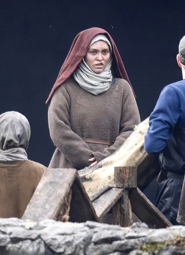 The first look at Lily-Rose Depp on the set of Robert Eggers’ Werwulf in Bourne Wood, England. Depp appears nearly unrecognizable in a gritty, medieval-inspired costume that reflects the film’s dark historical tone.