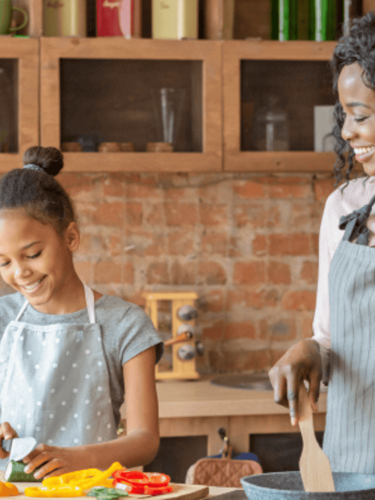 Freshly prepared healthy meal options for families and seniors featuring a mother and daughter cooking together in a cozy kitchen emphasizing nutritious food delivery with Meals in Motion