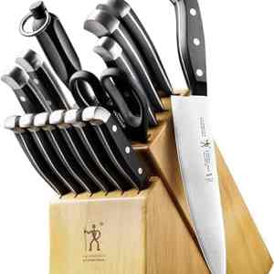 Knives in a wooden knife block set including various chef and utility knives with black handles for precise cooking and food prep