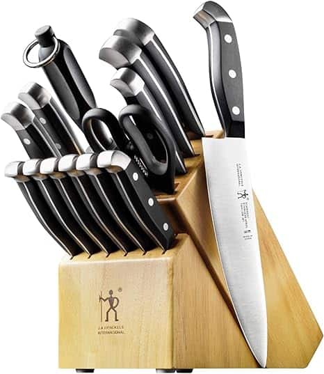 Knives in a wooden knife block set including various chef and utility knives with black handles for precise cooking and food prep