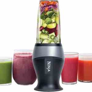 Blender with fresh vegetables and smoothies for healthy meals and nutrition focus on meal delivery service and wellness options for Meals in Motion