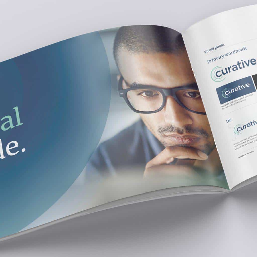open book laying flat on a table, featuring Curative logo and a contemplative man